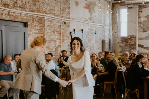 Guests pack the dance floor at a 24 Shelby wedding reception in downtown Indianapolis under Edison string lights and uplighting.